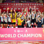 A team of athletes celebrates on a podium, holding a trophy and medals, with confetti falling and a banner reading "WORLD CHAMPION" below them.